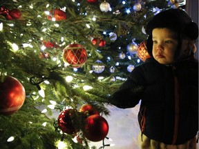 Two-year-old Lukas Crough admires a decorated Christmas tree on display during the annual Christmas In The Village, an event for the whole family, on Thursday December 3, 2015 in downtown Millbrook, Ont.