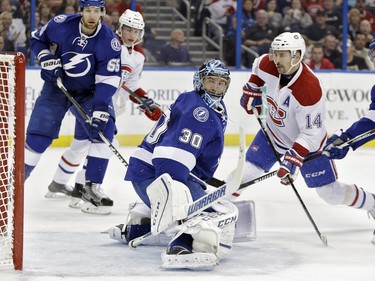 Montreal Canadiens center Tomas Plekanec (14), of the Czech Republic, watches his shot get past Tampa Bay Lightning goalie Ben Bishop (30) for a goal during the first period of an NHL hockey game Monday, Dec. 28, 2015, in Tampa, Fla. Defending for the Lightning are Braydon Coburn (55) and Tyler Johnson (9).