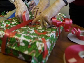 Volunteers wrap a present as part of a fundraising project for Lakeshore General Hospital November 20, 2007.