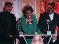 Gladys Knight, centre, William Guest, left, and Merald Knight take the stage as they are inducted into the Rock and Roll Hall of Fame during ceremonies in New York in 1996.