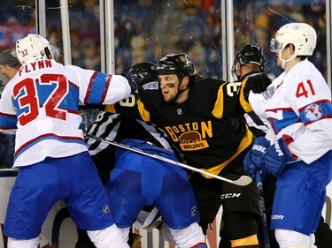 Matt Beleskey #39 of the Boston Bruins holds back Brian Flynn #32 and Paul Byron #41 of the Montreal Canadiens late in the third period during the 2016 Bridgestone NHL Winter Classic at Gillette Stadium on January 1, 2016, in Foxboro, Massachusetts.