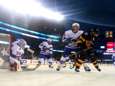 Jeff Petry #26 of the Montreal Canadiens and Patrice Bergeron #37 of the Boston Bruins compete for the puck in the third period during the 2016 Bridgestone NHL Winter Classic at Gillette Stadium on January 1, 2016, in Foxboro, Massachusetts.
