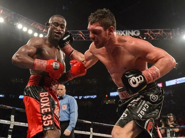 Francis Lafrèniere connects with a right punch on Renan St. Juste of Haiti during the IBF international middleweight title match at the Bell Centre on January 30, 2016 in Montreal.