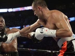 Jean Pascal, left, reacts as Sergey Kovalev lands a punch during their light heavyweight fight Saturday, January 30, 2016 at the Bell Centre in Montreal.