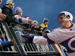 Canadiens' Brendan Gallagher greets fans as he comes off the ice following the NHL Winter Classic game against the Boston Bruins at Gillette Stadium in Foxborough, Mass., Friday, Jan. 1, 2016. The Canadiens won 5-1.