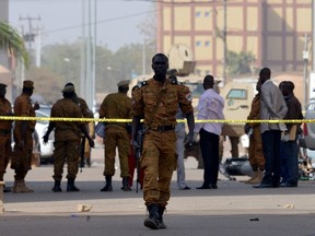 Burkina Faso's soldiers and investigators gather in front of the Splendid hotel and the cafe restaurant Capuccino on January 17, 2016 in Ouagadougou, following a jihadist attack by al-Qaida linked gunmen late on January 15.