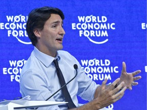 Canadian Prime Minister Justin Trudeau gestures as he speaks during a panel "Progress toward Parity" at the World Economic Forum in Davos, Switzerland, Friday, Jan. 22, 2016.