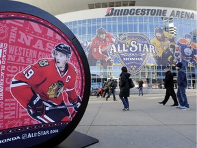 Chicago Blackhawks captain Jonathan Toews, bottom left, and Washington Capitals captain Alexander Ovechkin, top left, are featured on displays outside Bridgestone Arena, home of the 2016 NHL hockey All-Star game, Thursday, Jan. 28, 2016, in Nashville, Tenn. The league said Thursday that Toews won't play in the All-Star Game because of an illness. That came one day after Ovechkin pulled out of All-Star weekend with a lower-body injury. The game is scheduled to be played Sunday, Jan. 31.