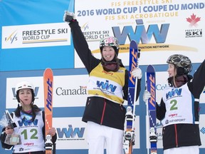 Canadians Chloé Dufour-Lapointe, centre, finishing first, Justine Dufour-Lapointe, right, finishing second, and Andi Naude, left, finishing third, stand on the podium at the FIS Freestyle Ski World Cup event in Calgary on Saturday, Jan. 30, 2016.