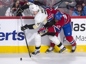 Montreal Canadiens' Devante Smith-Pelly hangs on to Pittsburgh Penguins' Evgeni Malkin  during first period NHL hockey action Saturday, Jan. 9, 2016, in Montreal.