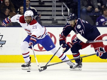 Montreal Canadiens' Devante Smith-Pelly, left, works for the puck against Columbus Blue Jackets' Nick Foligno  during the second period of an NHL hockey game in Columbus, Ohio, Monday, Jan. 25, 2016.