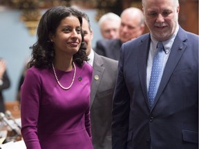 Dominique Anglade enters the legislature with Premier Philippe Couillard after her swearing-in at the National Assembly on Nov. 17, 2015.