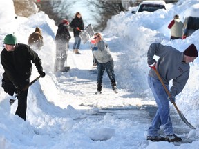 Residents of W. Leicester St. in Winchester, Va. join forces to shovel out on Sunday, Jan. 24, 2016, after an historic snowstorm dumped more than 30 inches of snow on the city Friday night and Saturday.