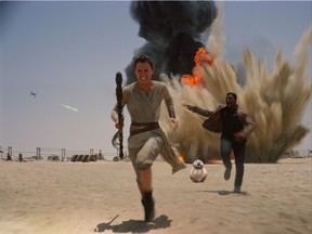Daisey Ridley as Rey, left, and John Boyega as Finn, in a scene from the film, "Star Wars: The Force Awakens." (Disney/Lucasfilm via AP, File)