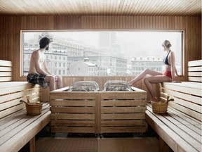 A couple warms up in the sauna at Bota Bota, with views onto Old Montreal.