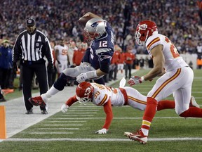 Kansas City Chiefs free safety Husain Abdullah (39) pushes New England Patriots quarterback Tom Brady (12) out of bounds short of the goal line in the first half of an NFL divisional playoff football game, Saturday, Jan. 16, 2016, in Foxborough, Mass.