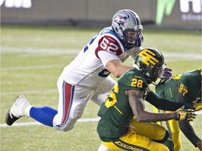 Montreal Alouettes offensive-lineman Jake Piotrowski (62) chases the fumble with Edmonton Eskimos John Ojo (26) and Otha Foster (37) during second half action in Edmonton, Alta., on Sunday November 1, 2015.