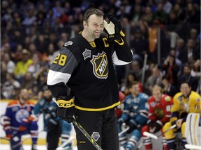 John Scott listens to the cheers as he gets ready to compete in the hardest shot competition at the NHL hockey All-Star game skills competition Saturday, Jan. 30, 2016, in Nashville. Scott was elected as captain of the Pacific Division while with the Arizona Coyotes. He was traded to the Montreal Canadiens and he is now with the Canadiens' AHL affiliate in Newfoundland.