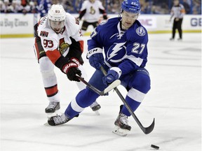 Tampa Bay Lightning left wing Jonathan Drouin (27) loses the puck to a stick-check by Ottawa Senators centre Mika Zibanejad (93), of Sweden, during the first period of an NHL hockey game Thursday, Dec. 10, 2015, in Tampa, Fla.