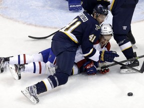 St. Louis Blues' Robert Bortuzzo (41) and Montreal Canadiens' Lars Eller, of Denmark, keep their eyes on the puck during the second period of an NHL hockey game Saturday, Jan. 16, 2016, in St. Louis.