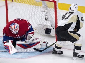 Montreal Canadiens goalie Mike Condon makes a save off Pittsburgh Penguins' Sidney Crosby during first period NHL hockey action Saturday, Jan. 9, 2016, in Montreal.