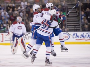 Canadiens centre Lars Eller (81) is congratulated by teammates P.K. Subban (76) and Devante Smith-Pelley (21) after scoring the game winning shootout goal against the Toronto Maple Leafs in NHL action in Toronto on Saturday, Jan. 23, 2016.