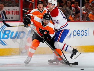 Pierre-Edouard Bellemare of the Philadelphia Flyers and Alexei Emelin of the Montreal Canadiens collide in the first period at the Wells Fargo Center on January 5, 2016 in Philadelphia, Pennsylvania.