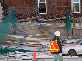 A CSST inspector examines the site where a scaffold collapsed  injuring 4 workers who were working on the side wall (on Marie-Anne) of a building whose address is on des Erables street in Montreal April 8, 2011.