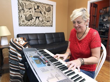 Myriam Rochet plays the piano in the living room of her Verdun flat. (John Mahoney / MONTREAL GAZETTE)
