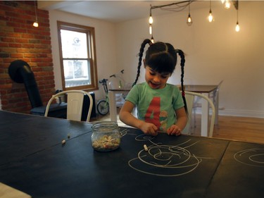 Four-year-old Augustine scribbles with chalk on the black slate kitchen countertop. (Marie-France Coallier / MONTREAL GAZETTE)