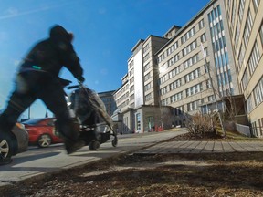 A man pushes a child in a stroller towards Ste-Justine Hospital in Montreal, on Tuesday, Dec. 30, 2014.