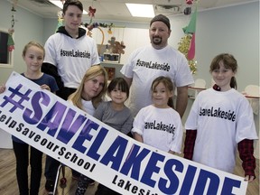 Jennifer Park, 2nd from left, and her family n the playroom of Park Place Daycare, where she is the director, in Montreal on Wednesday Dec. 30, 2015. Park is leading a campaign to save Lakeside Academy, the last English high school in Lachine and Dorval. Front row, left to right, Sammy De Luca, 10, Leila De Luca, 5, Chase De Luca, 6, Jayme de Luca, 12. Back row: Shane De Luca, left,  and Park's husband Jonathan Deluca