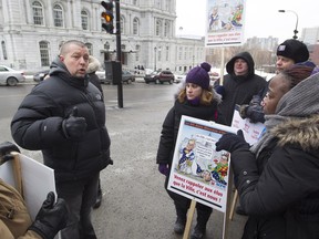 Alain Fugère, president of the white-collar union (left) speaks to his members of the public sector workers protesting outside Montreal city hall and municipal buildings   Monday, January 25, 2016. The union began rotating strikes.