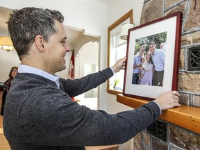 Rookie MP Peter Schiefke places photo of himself and his wife and child with Prime Minister Justin Trudeau on the mantle in his new riding office in Vaudreuil-Dorion on Tuesday, January 5, 2016. (John Mahoney / MONTREAL GAZETTE)