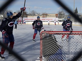 Canadiens centre Alex Galchenyuk (left),  defencemen Alexei Emelin and Mark Barberio run drills against goalie Mike Condon during outdoor practice at Parc Émile in Laval on Jan. 11, 2016.