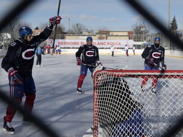 Montreal Canadiens centre Alex Galchenyuk, left to right, Alexei Emelin and defenseman Mark Barberio run drills against goalie Mike Condon during a team practice in Parc Emile in tLaval on Monday, Jan. 11, 2016.