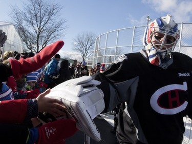 Montreal Canadiens goalie Ben Scrivens gives school kids a high-five in Parc Emile in Laval on Monday, Jan. 11, 2016. The Canadiens practiced on the new Montreal Canadiens Foundation Blue Blanc Rouge rink in the park after the opening ceremony.