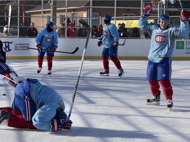 Montreal Canadiens right wing Devante Smith-Pelly, bottom left, and right wing Brendan Gallagher celebrate scoring against goalie Ben Scrivens in Parc Emile in Laval on Monday, Jan. 11, 2016. The team was practicing on the new Montreal Canadiens Foundation Blue Blanc Rouge rink that opened today.