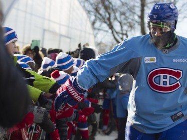 Montreal Canadiens right wing Devante Smith-Pelly gives school kids a high-five in Parc Emile in Laval on Monday, Jan. 11, 2016.