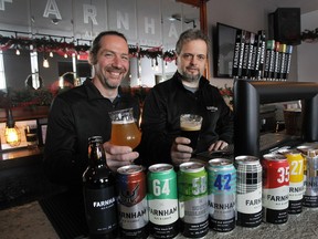 Hugues Ouellet, co-owner, left and Jean Gadoua, general manager, behind the bar of the tasting room of Farnham Beer & Ale, their small brewery in Farnham, Quebec.