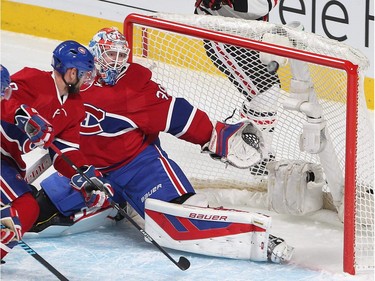 Chicago Blackhawks centre Andrew Shaw (65) watches puck get past Montreal Canadiens goalie Mike Condon while Montreal Canadiens' Andrei Markov looks on during first period NHL action in Montreal on Thursday January 14, 2016. The goal was scored by Chicago Blackhawks' Jonathan Toews.