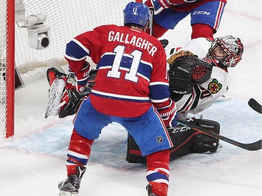 Chicago Blackhawks goalie Corey Crawford stops puck on Montreal Canadiens right wing Brendan Gallagher (11) and teammate Tomas Plekanec (14) during third period NHL action in Montreal on Thursday January 14, 2016.