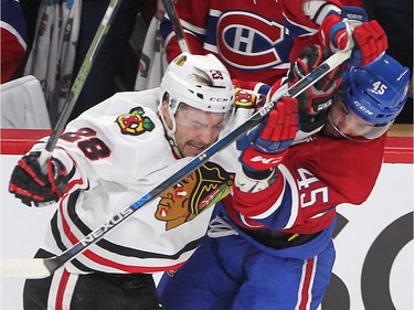Chicago Blackhawks left wing Ryan Garbutt (28) and Montreal Canadiens defenceman Mark Barberio meet head on at mid-ice during first period NHL action in Montreal on Thursday January 14, 2016.