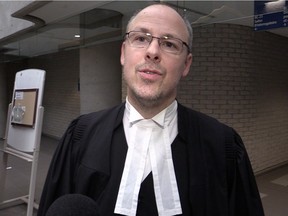 Crown prosecutor Patrick Lafrenière explains to the media that the four people arrested for fraud and profiting from the proceeds of a crime were arraigned and released on their own recognizance on Thursday, January 14, 2015 at the Palais de Justice in Longueuil.