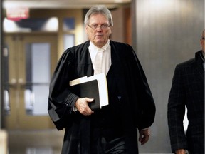 Defense lawyer François Bérichon walks out of  the courtroom on Thursday, Jan. 14, 2015, at the Montreal courthouse, where Idelson Guerrier in on trial, accused of killing  two psychiatric patients at Notre-Dame Hospital Hospital in 2012.