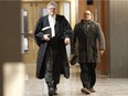 Defense lawyer Francois Berichon, middle, walks out of the courtroom on Thursday at the Montreal courthouse during the hearing of Idelson Guerrier in the trial for the murder of two patients at Notre Dame Hospital in 2012.