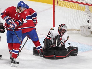 Montreal Canadiens left wing Max Pacioretty (67) and Montreal Canadiens' Tomas Plekanec (14) look at puck bounce off Chicago Blackhawks goalie Corey Crawford during second period NHL action in Montreal on Thursday January 14, 2016.