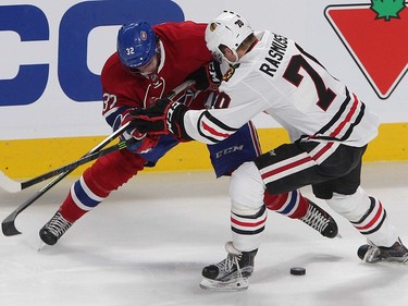 Montreal Canadiens right wing Brian Flynn (32) tries to get to the puck while battling Chicago Blackhawks left wing Dennis Rasmussen (70) during second period NHL action in Montreal on Thursday January 14, 2016.