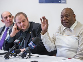 Edouard Narcisse, right, interim president of the Black Coalition of Quebec, speaks alongside city councillors Marvin Rotrand, left, and Benoit Dorais, centre, during a press conference to call for increased representation of visible minorities within city council in Montreal on Monday, Jan. 18, 2016.
