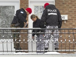 Montreal police officers at the entrance to a home on Théodore Street near the corner with Ontario Street in Montreal, Monday January 18, 2016, where a man in his 30's was found dead in the Hochelaga-Maisonneuve district home  overnight.